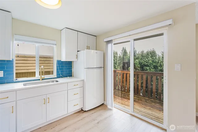 a bathroom with a granite countertop sink toilet mirror vanity and bathtub
