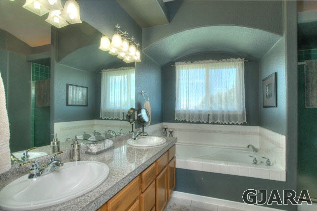 1598 P Road Loma, CO 81524 - Photo 12 of 25 a bathroom with a granite countertop sink a large mirror and a bathtub