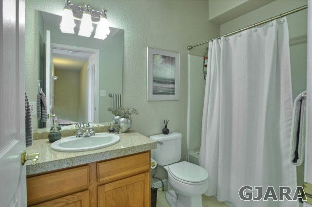 1598 P Road Loma, CO 81524 - Photo 15 of 25 a bathroom with a granite countertop sink toilet and a mirror