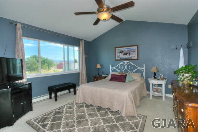 1598 P Road Loma, CO 81524 - Photo 10 of 25 a bedroom with a bed and a desk