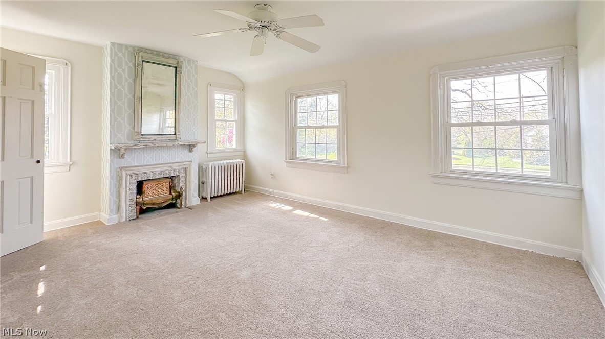 25819 Center Ridge Road Westlake, OH 44145 - Photo 17 of 45 Master bedroom featuring a healthy amount of sunlight, new carpet, and a fireplace