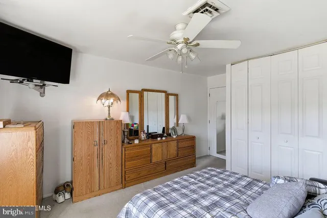 a bedroom with a bed and flat screen tv