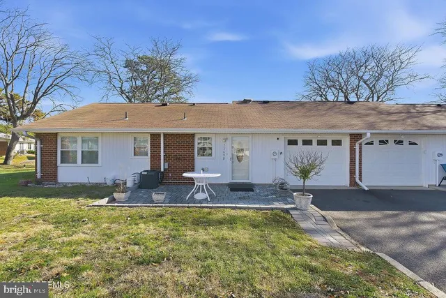 a front view of house with yard having outdoor seating