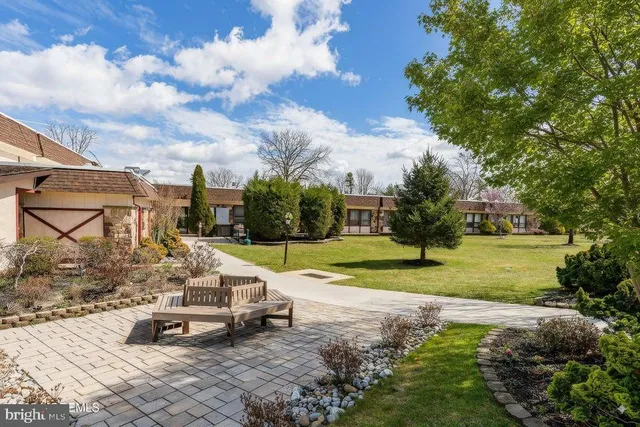 a view of a house with backyard sitting area and garden