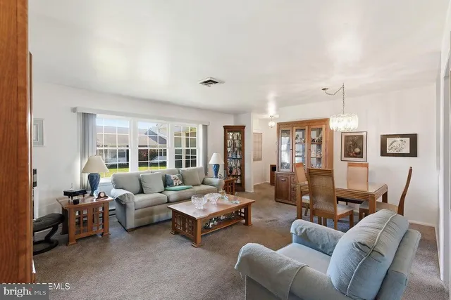 a living room with furniture and large windows