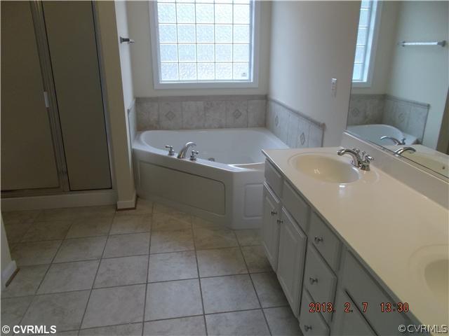 10320 Cattail Road Chesterfield, VA 23838 - Photo 14 of 24 a bathroom with a sink a vanity and bathtub