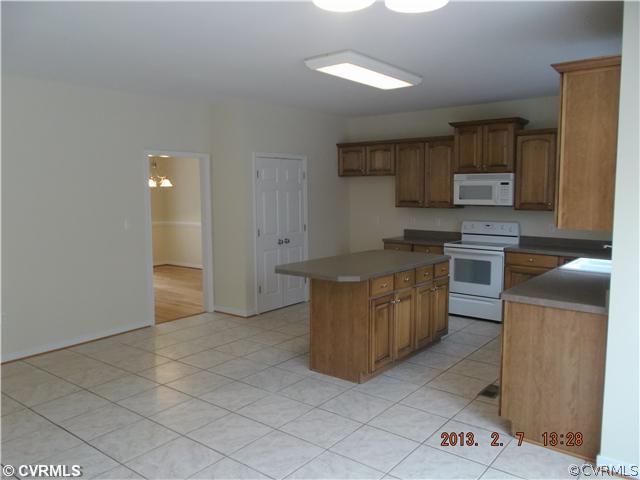 10320 Cattail Road Chesterfield, VA 23838 - Photo 4 of 24 a kitchen with stainless steel appliances granite countertop a stove a sink and a refrigerator