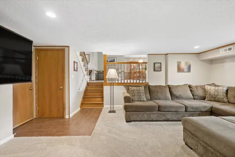 a living room with couches and a flat screen tv