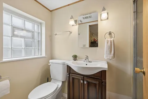 a bathroom with a sink a toilet and mirror