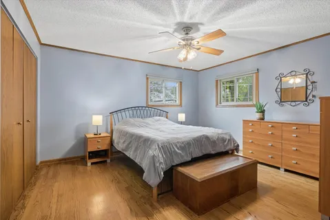 a spacious bedroom with a bed and a chandelier