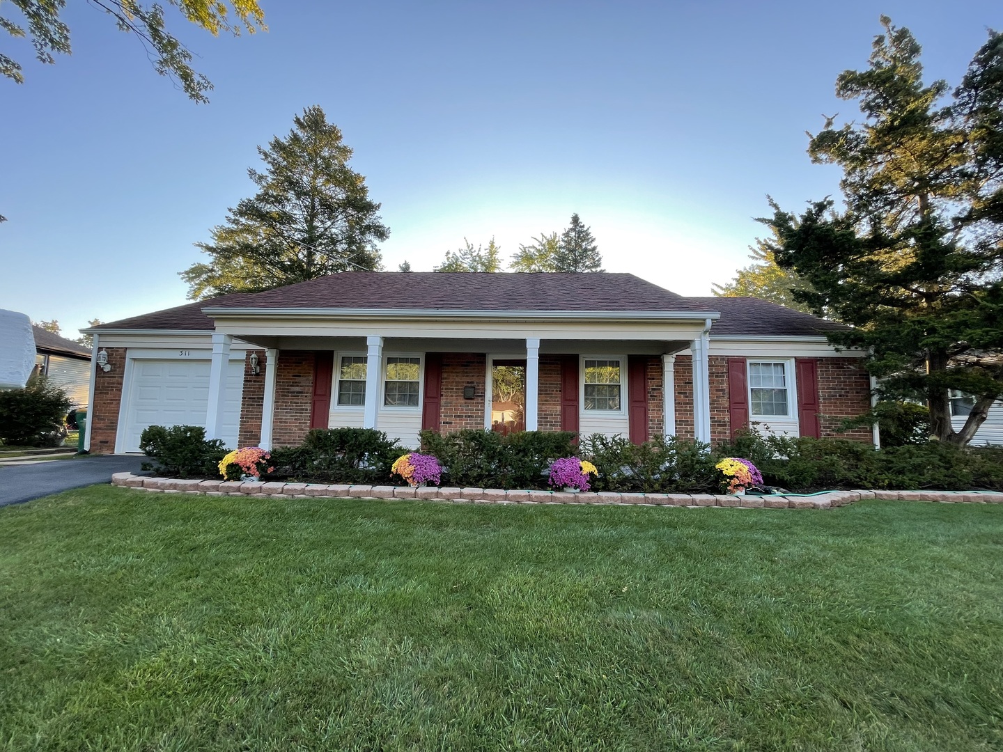 311 Weidner Road Buffalo Grove, IL 60089 - Photo 1 of 16 a front view of a house with a garden and plants
