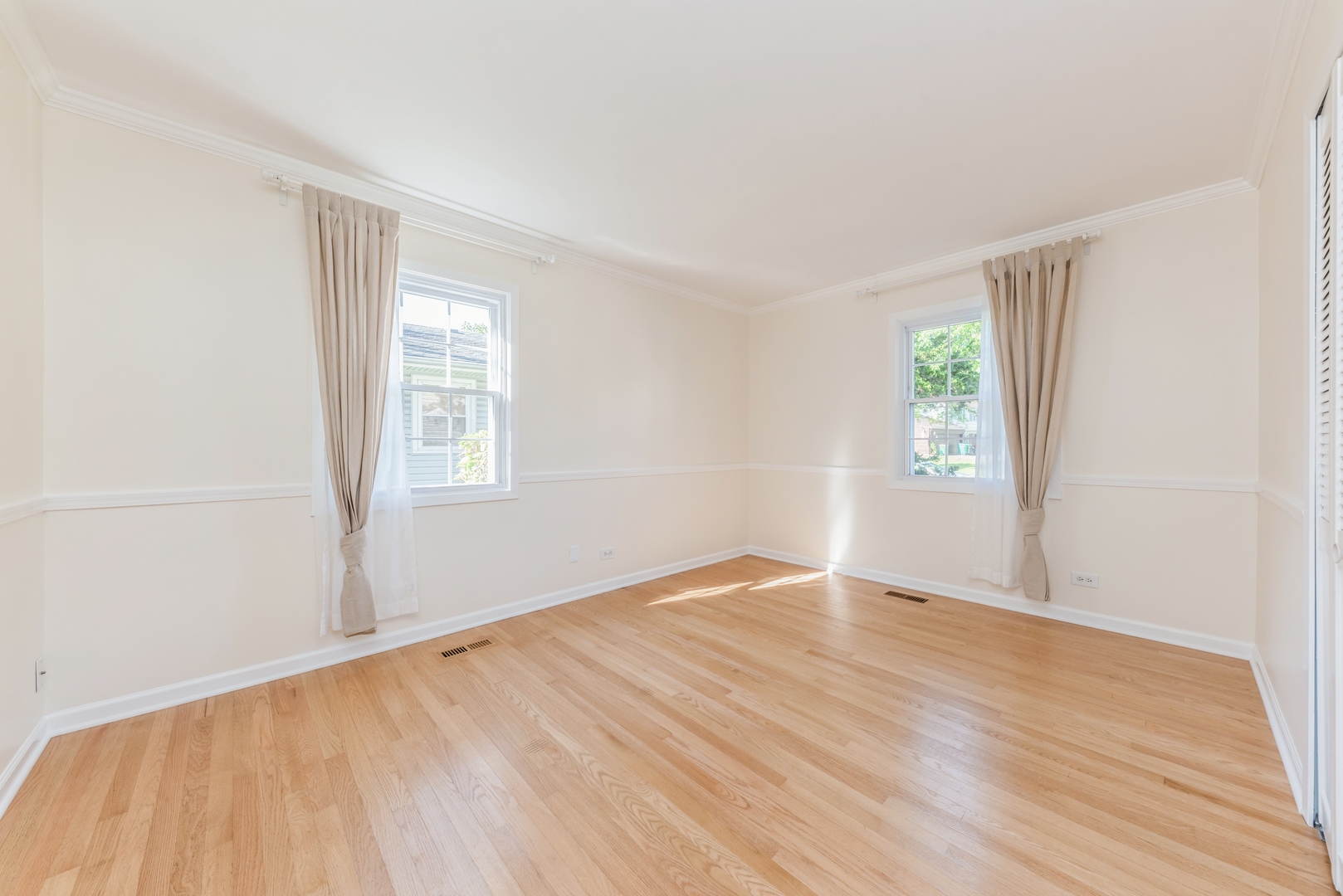 311 Weidner Road Buffalo Grove, IL 60089 - Photo 11 of 16 an empty room with wooden floor and windows