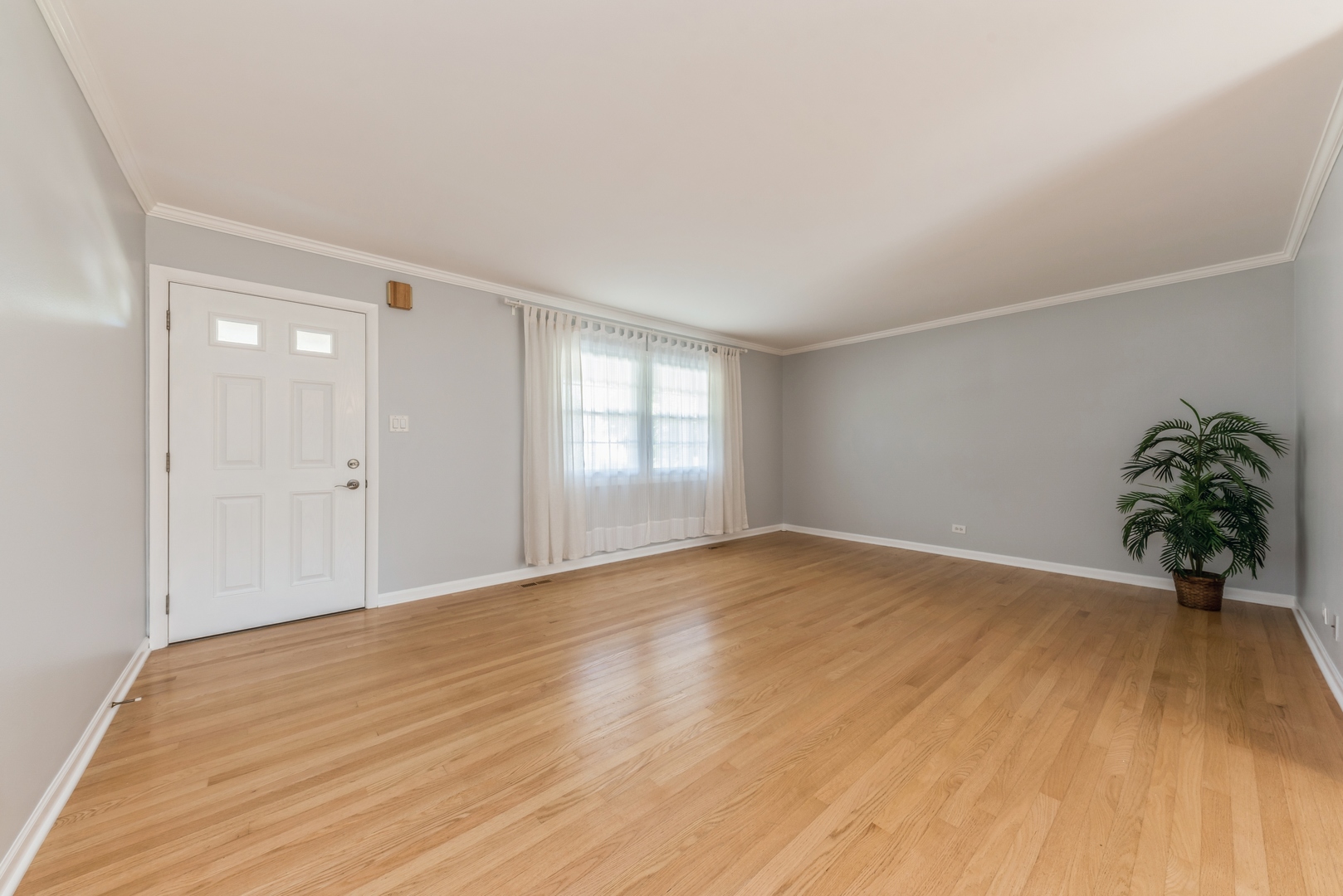 311 Weidner Road Buffalo Grove, IL 60089 - Photo 3 of 16 a view of empty room with wooden floor and fan