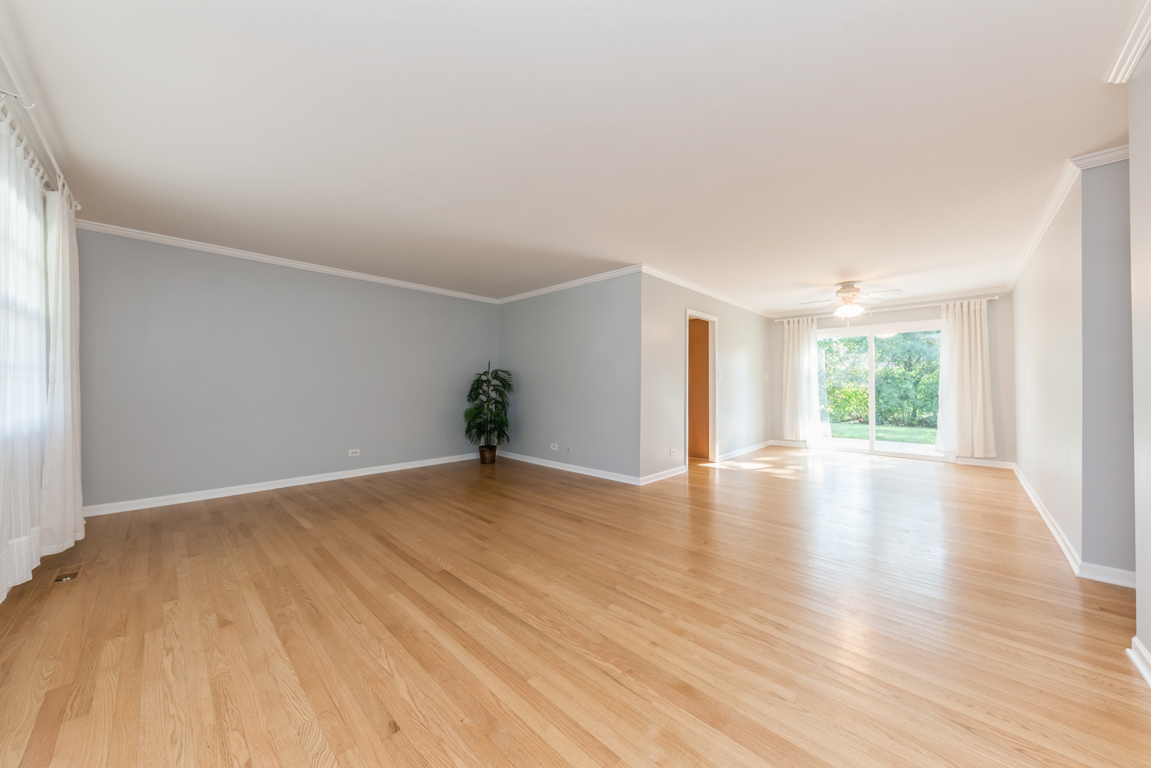 311 Weidner Road Buffalo Grove, IL 60089 - Photo 4 of 16 an empty room with wooden floor and windows