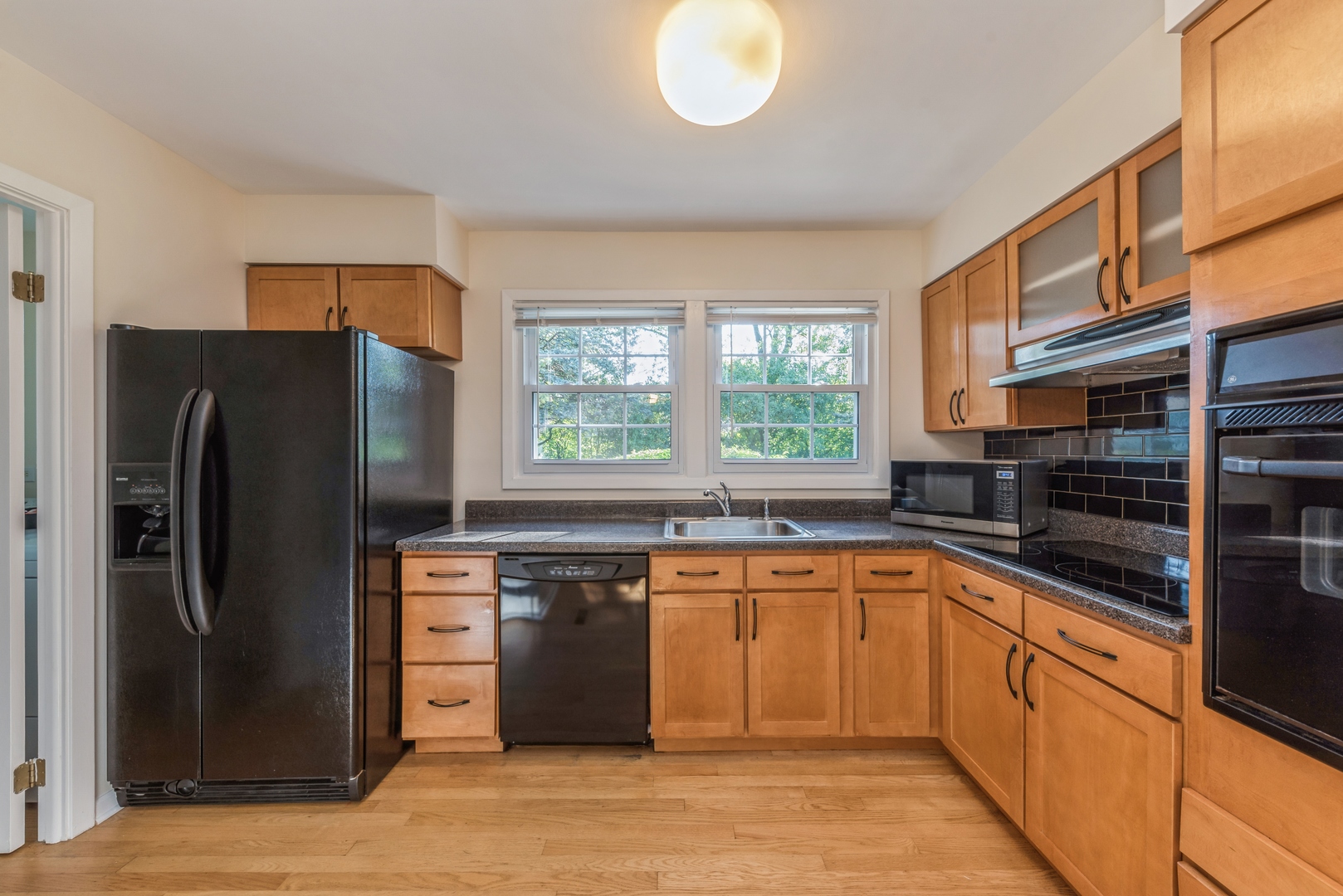 311 Weidner Road Buffalo Grove, IL 60089 - Photo 5 of 16 a kitchen with stainless steel appliances granite countertop a refrigerator a sink a stove and a microwave