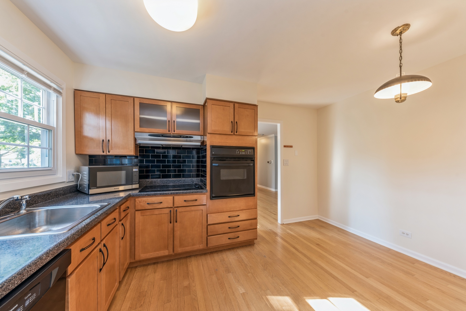 311 Weidner Road Buffalo Grove, IL 60089 - Photo 6 of 16 a kitchen with stainless steel appliances a sink cabinets and wooden floor