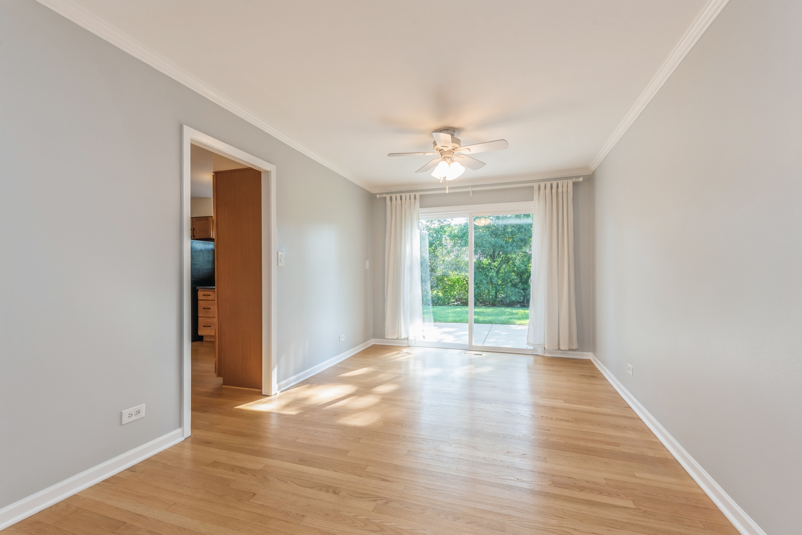 311 Weidner Road Buffalo Grove, IL 60089 - Photo 7 of 16 a view of an empty room with wooden floor and a window