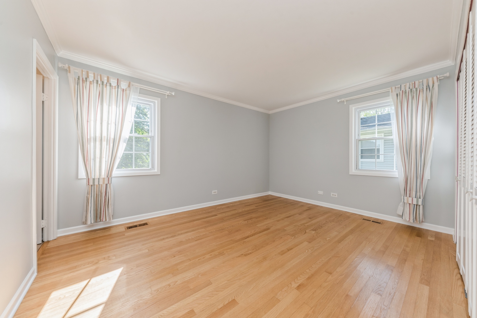 311 Weidner Road Buffalo Grove, IL 60089 - Photo 8 of 16 a view of an empty room with wooden floor and a window