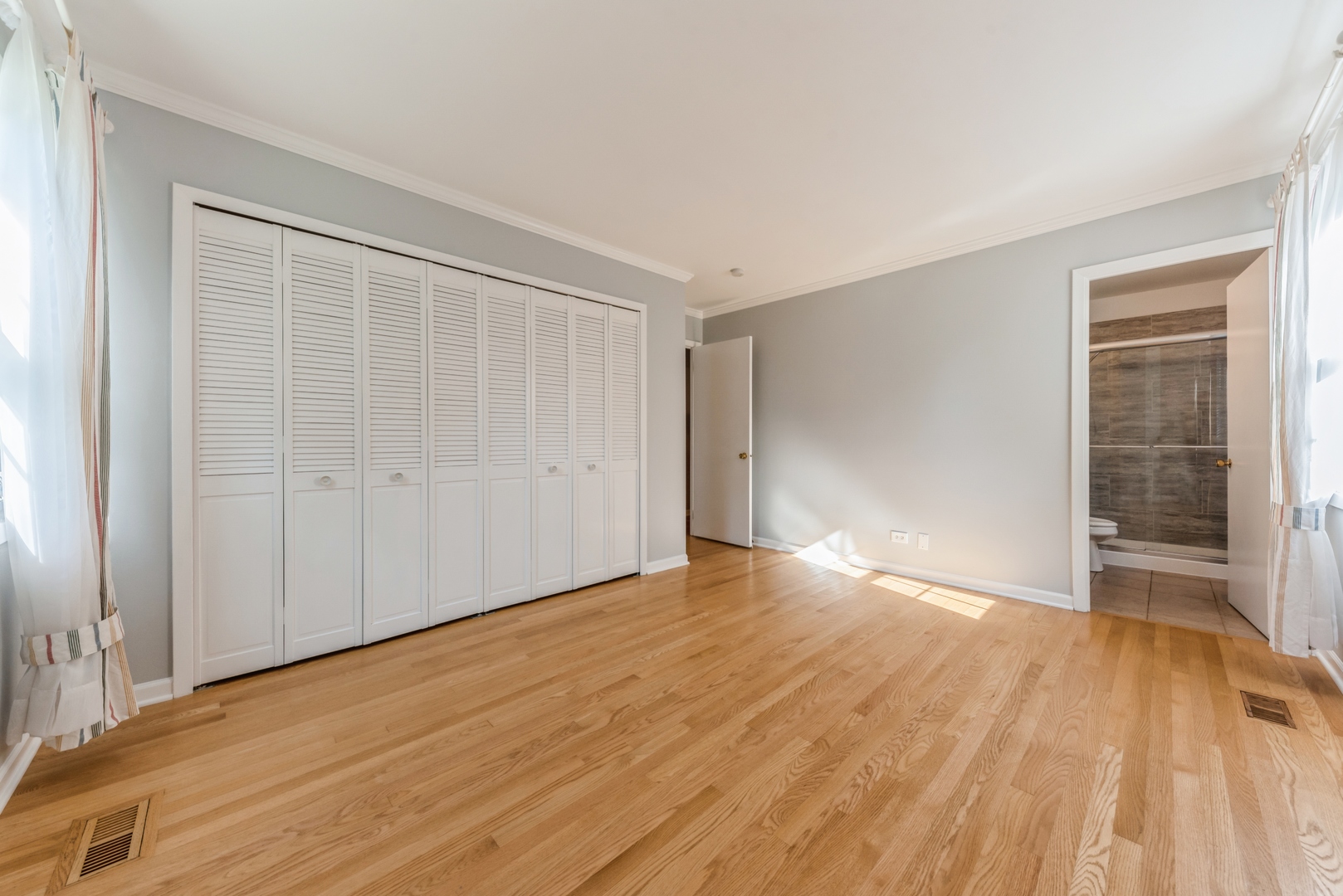 311 Weidner Road Buffalo Grove, IL 60089 - Photo 9 of 16 a view of empty room with wooden floor and fan
