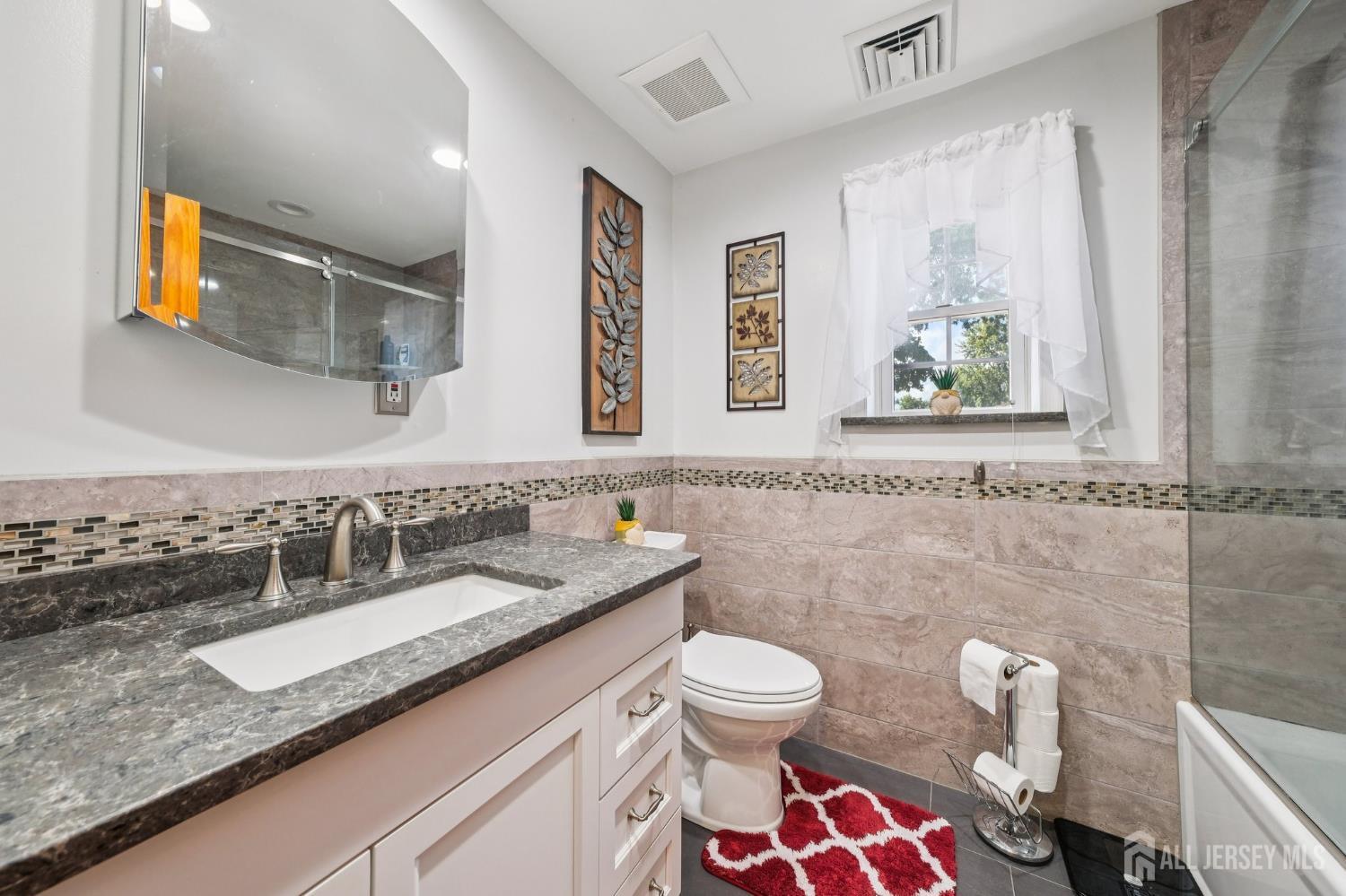 187 Hoover Avenue Edison, NJ 08837 - Photo 14 of 29 a bathroom with a granite countertop sink and a mirror