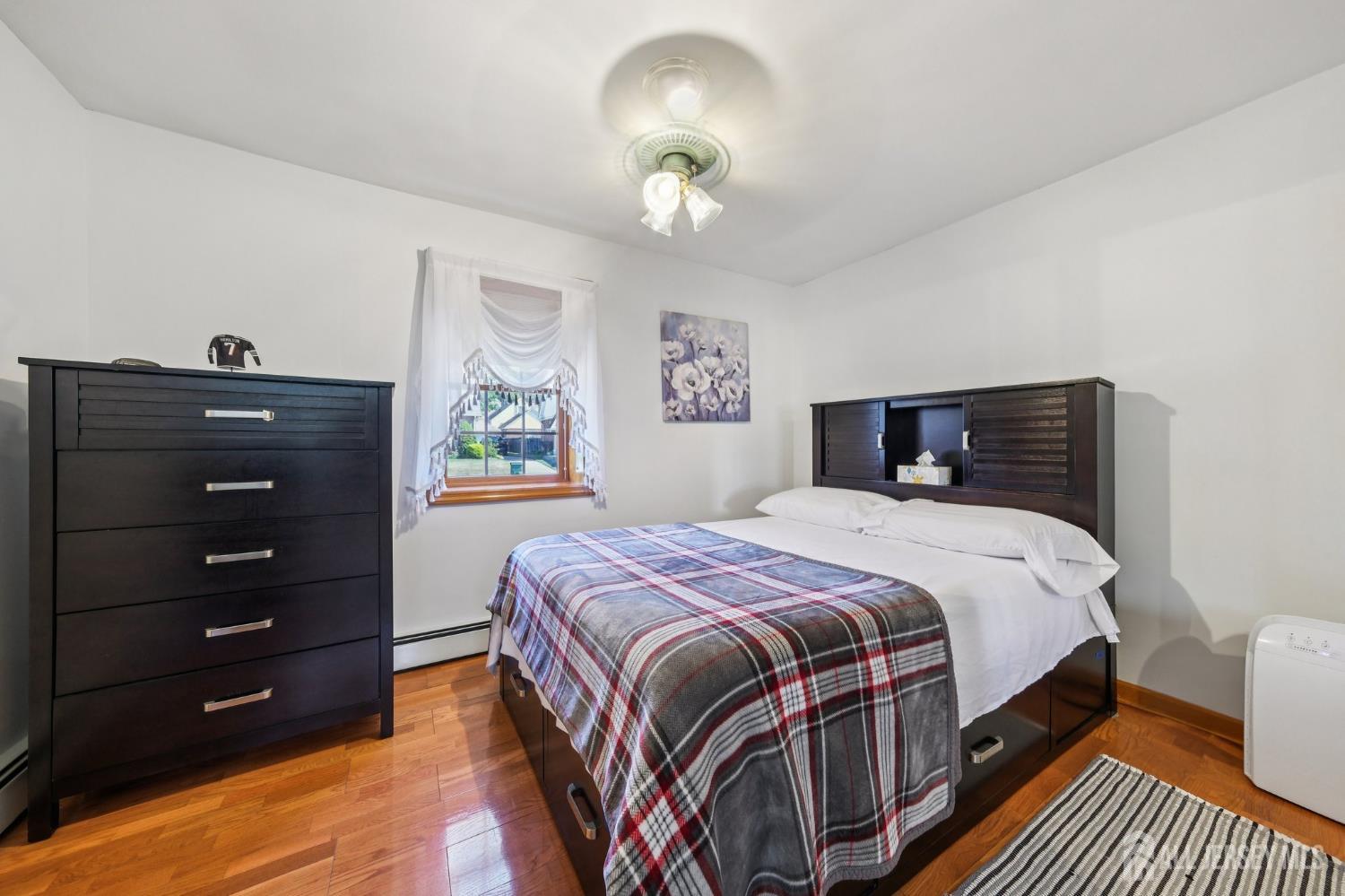 187 Hoover Avenue Edison, NJ 08837 - Photo 15 of 29 a bedroom with a bed and a lamp