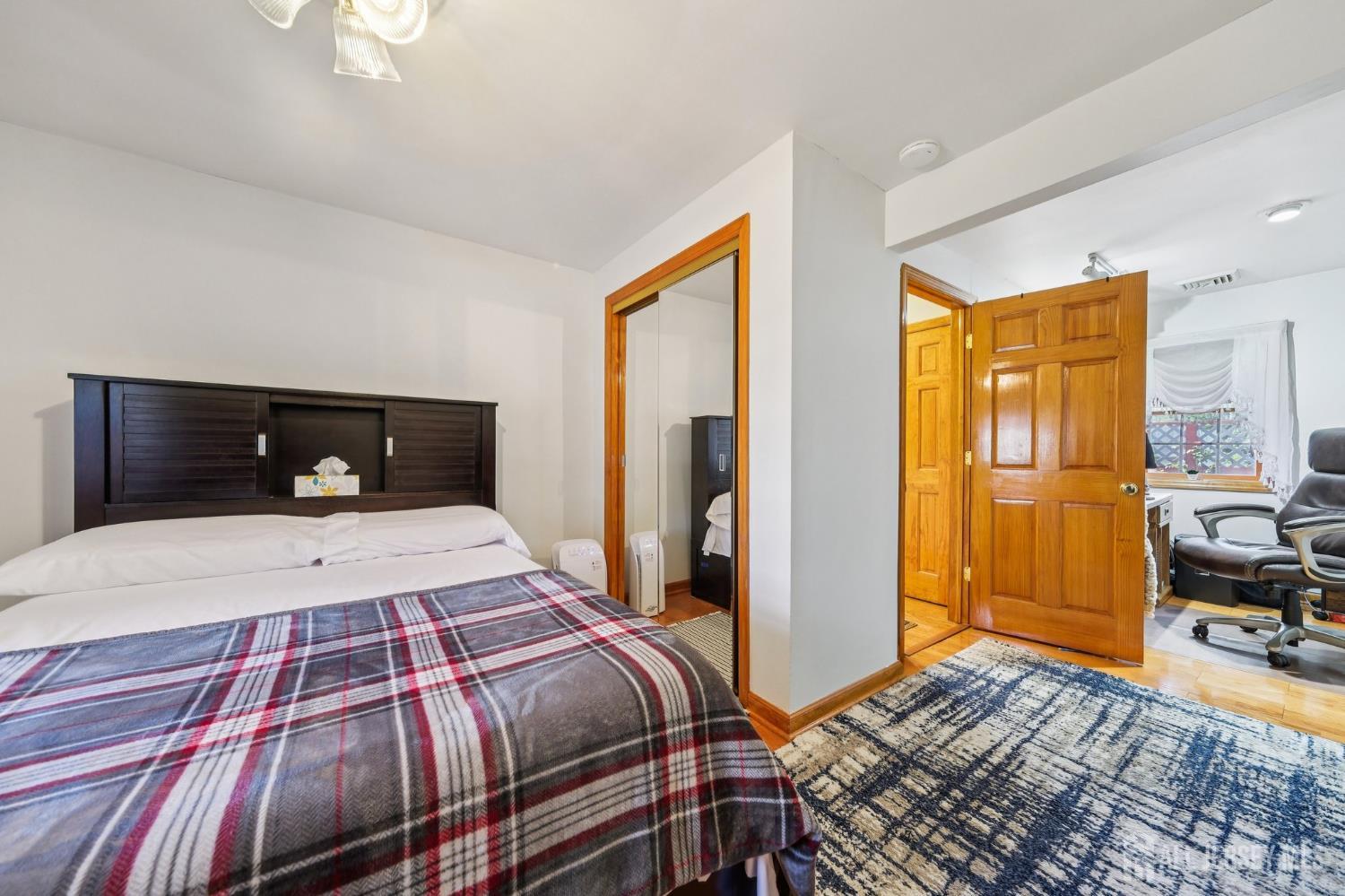 187 Hoover Avenue Edison, NJ 08837 - Photo 16 of 29 a bedroom with a bed and wooden floor