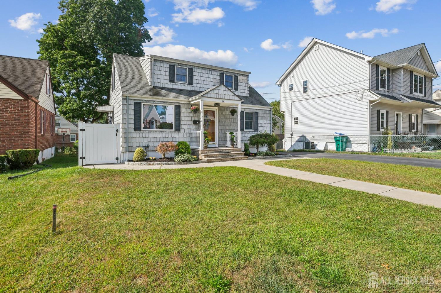187 Hoover Avenue Edison, NJ 08837 - Photo 3 of 29 a front view of a house with a yard table and chairs
