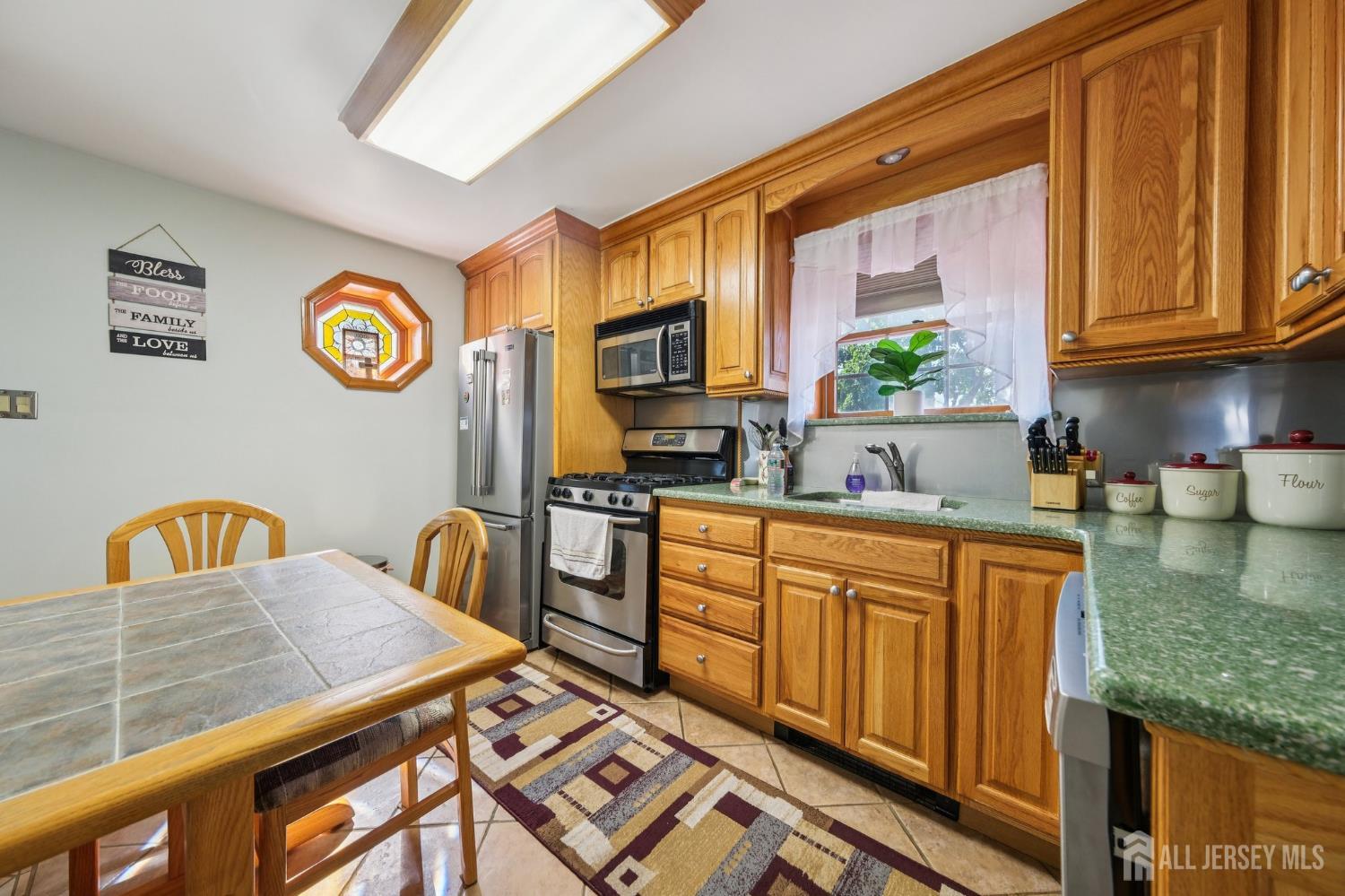 187 Hoover Avenue Edison, NJ 08837 - Photo 6 of 29 a kitchen with stainless steel appliances granite countertop a stove a sink and a microwave