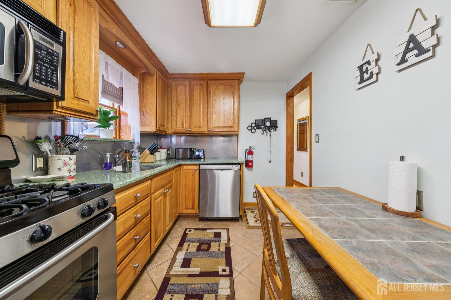 187 Hoover Avenue Edison, NJ 08837 - Photo 7 of 29 a kitchen with stainless steel appliances granite countertop a stove a sink and a refrigerator