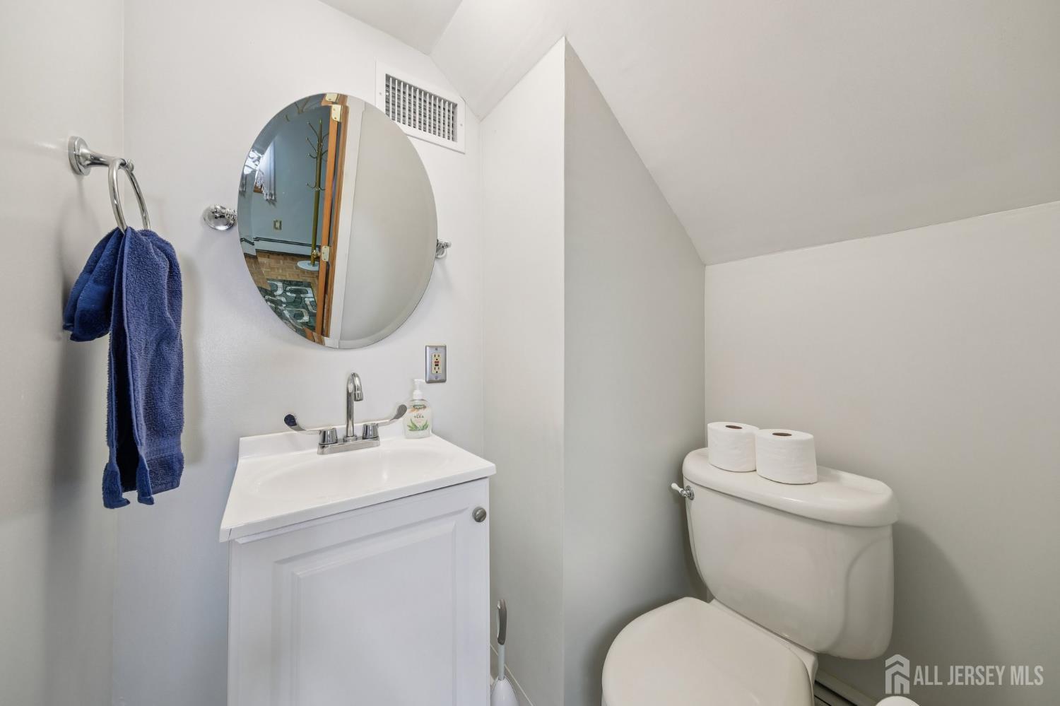 187 Hoover Avenue Edison, NJ 08837 - Photo 9 of 29 a bathroom with a toilet sink and mirror