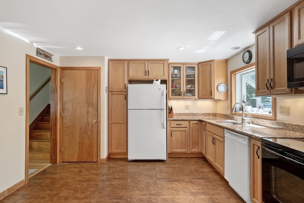 122 Chickering Road Dedham, MA 02026 - Photo 11 of 41 a kitchen with stainless steel appliances granite countertop a refrigerator stove a sink and dishwasher