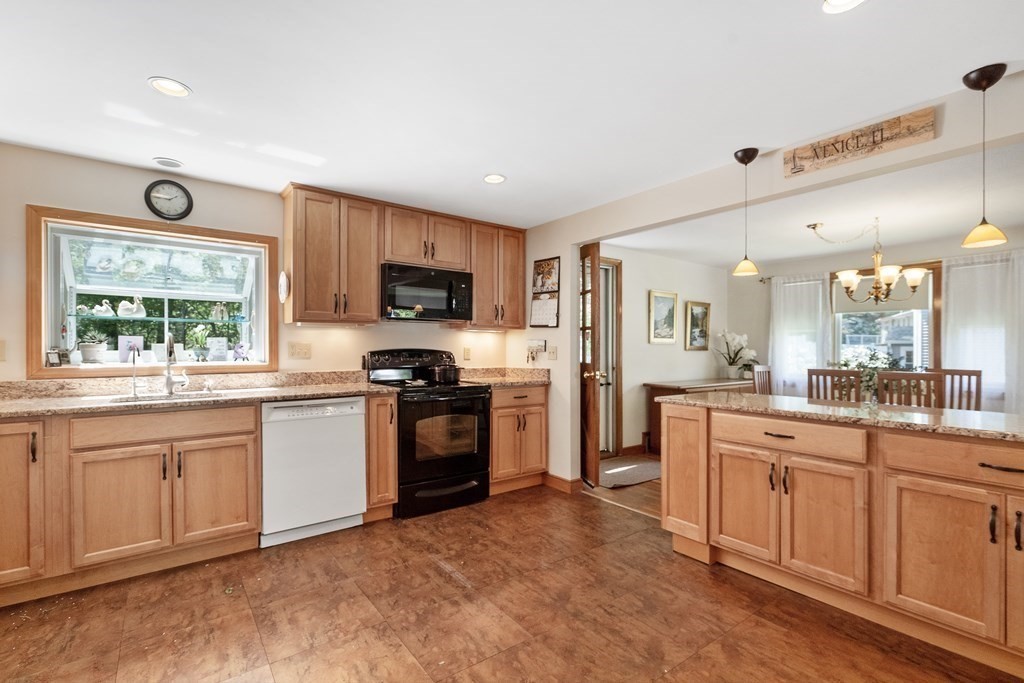 122 Chickering Road Dedham, MA 02026 - Photo 13 of 41 a large kitchen with cabinets a sink a window and stainless steel appliances
