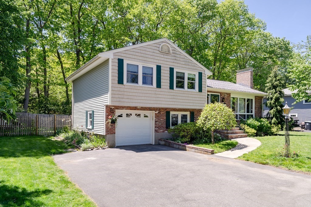 122 Chickering Road Dedham, MA 02026 - Photo 2 of 41 a house with a yard and a large tree