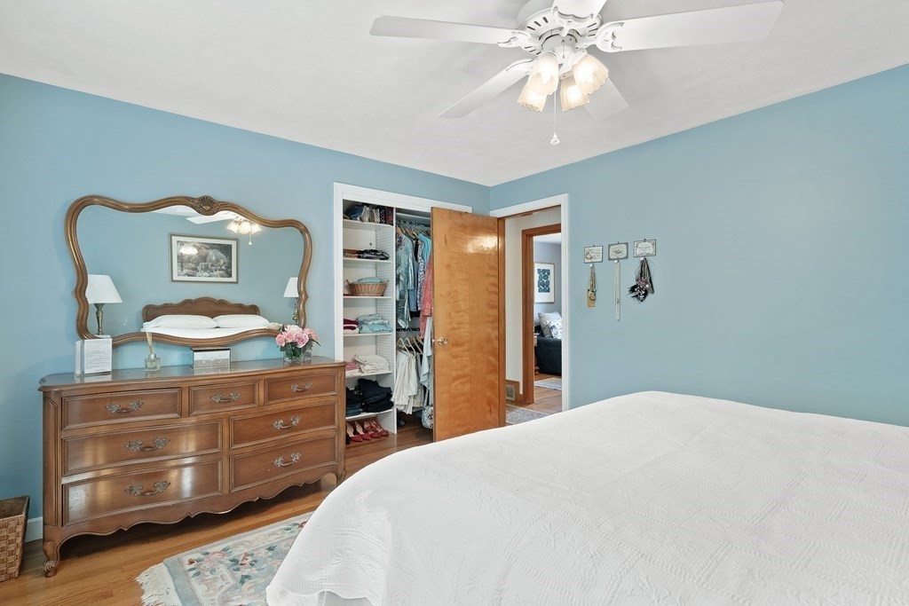 122 Chickering Road Dedham, MA 02026 - Photo 22 of 41 a bedroom with a bed and a chandelier