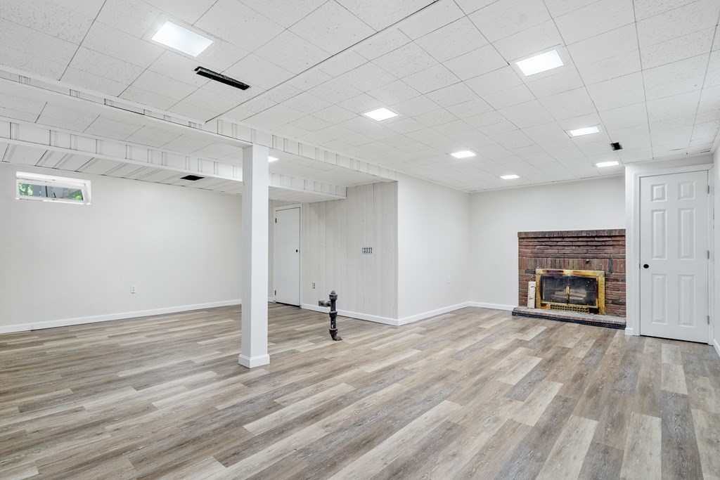 122 Chickering Road Dedham, MA 02026 - Photo 33 of 41 a view of empty room with wooden floor and fireplace