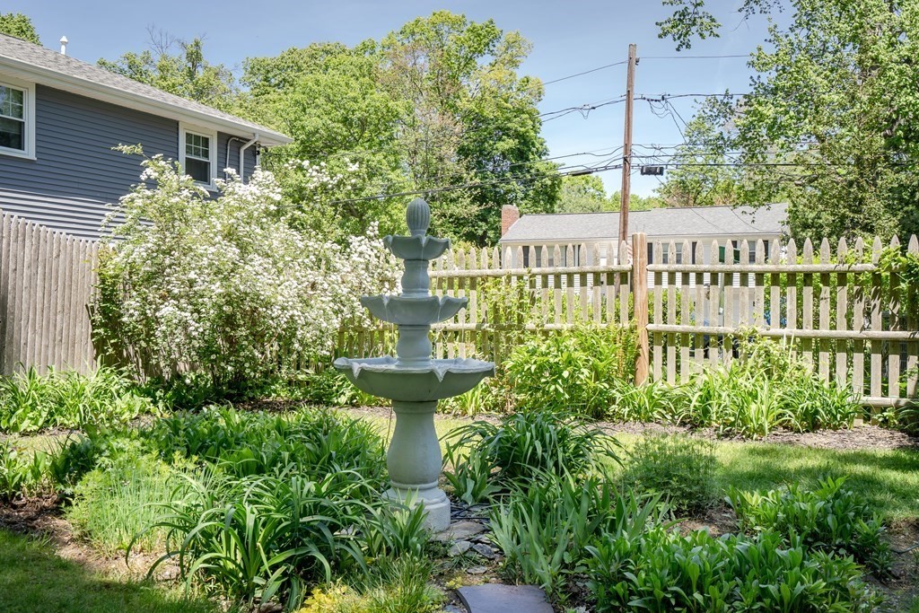 122 Chickering Road Dedham, MA 02026 - Photo 37 of 41 a view of a house with brick walls and flower plants