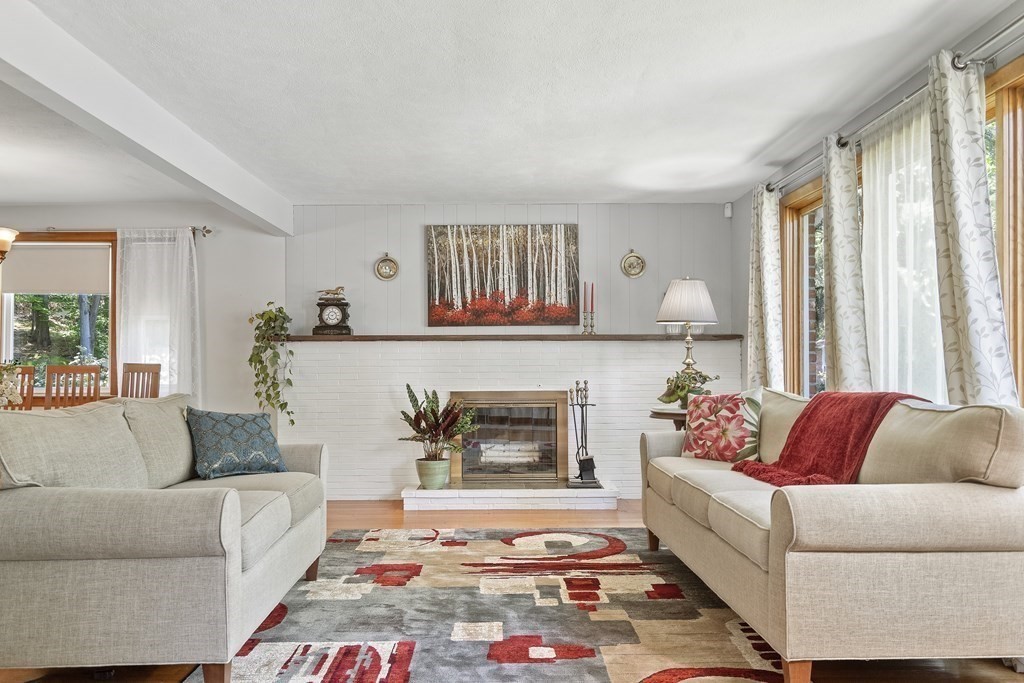122 Chickering Road Dedham, MA 02026 - Photo 4 of 41 a living room with furniture and a fireplace