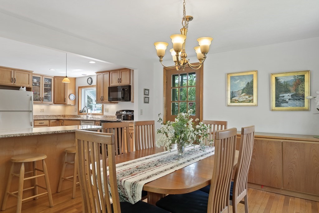 122 Chickering Road Dedham, MA 02026 - Photo 8 of 41 a view of a dining room with furniture a chandelier and wooden floor