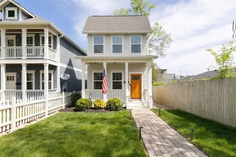 a front view of a house with a yard and porch
