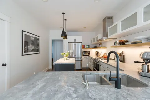 a stove top oven sitting inside of a kitchen
