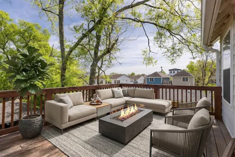 a view of backyard with patio area and outdoor seating