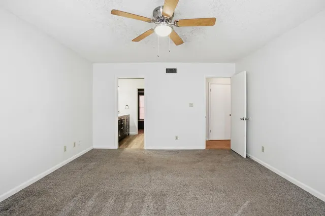 a spacious bathroom with a double vanity sink a mirror and a bathtub