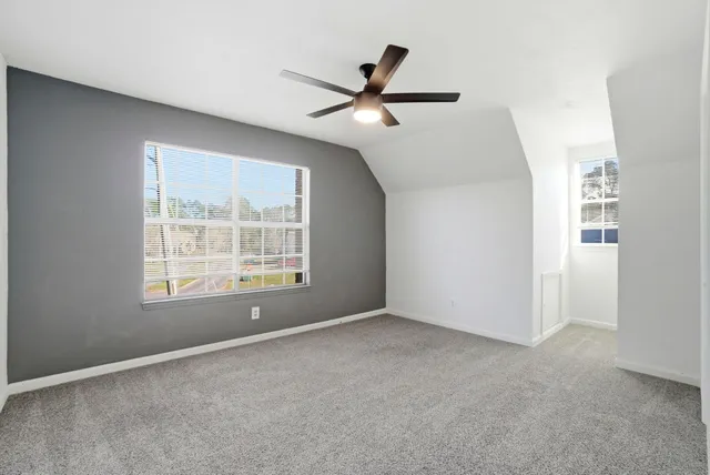 a bathroom with a sink a toilet a mirror and shower curtain