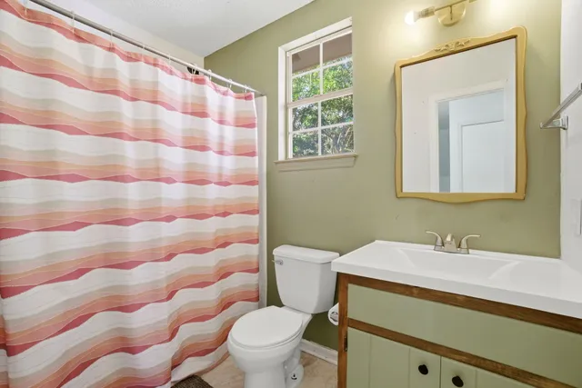a view of a livingroom with a ceiling fan and window