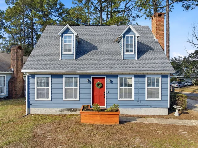 a house view with a sitting space and garden