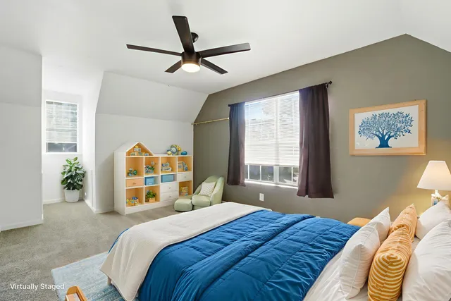 a view of a livingroom with a ceiling fan and window