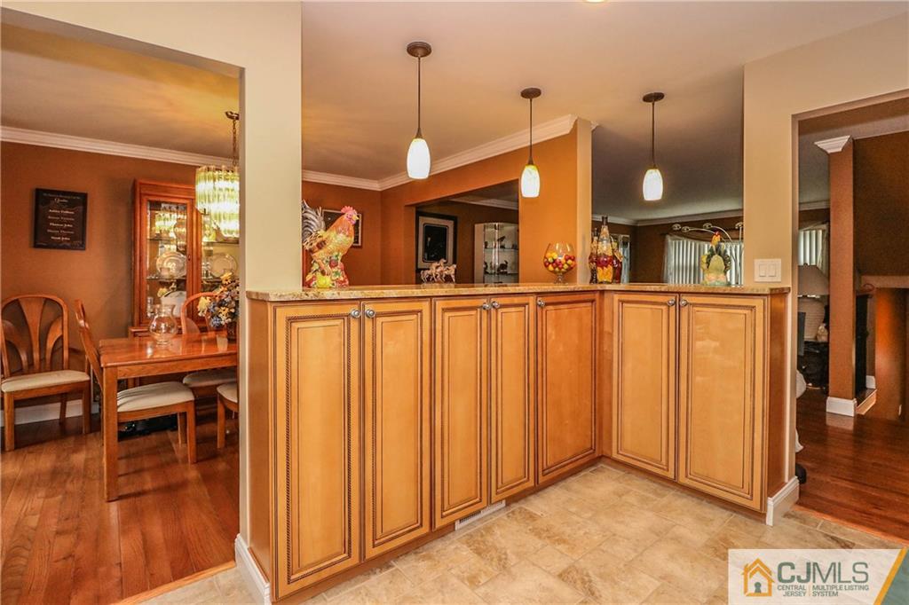 7307 Hana Road Edison, NJ 08817 - Photo 11 of 24 a view of a living room and kitchen with furniture wooden floor and windows