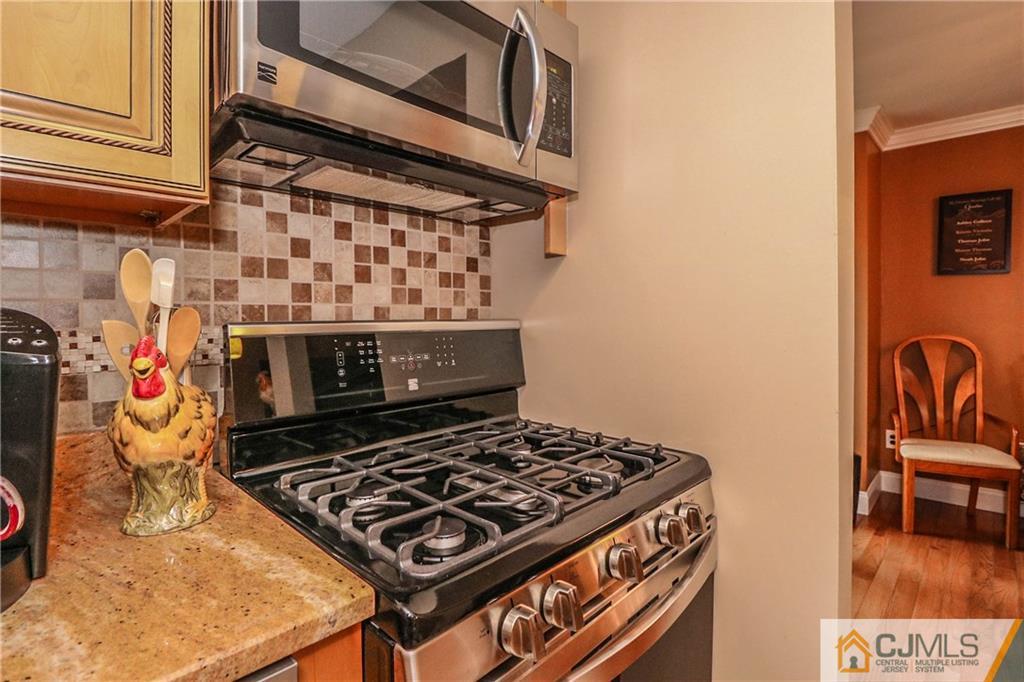 7307 Hana Road Edison, NJ 08817 - Photo 12 of 24 a stove top oven sitting inside of a kitchen
