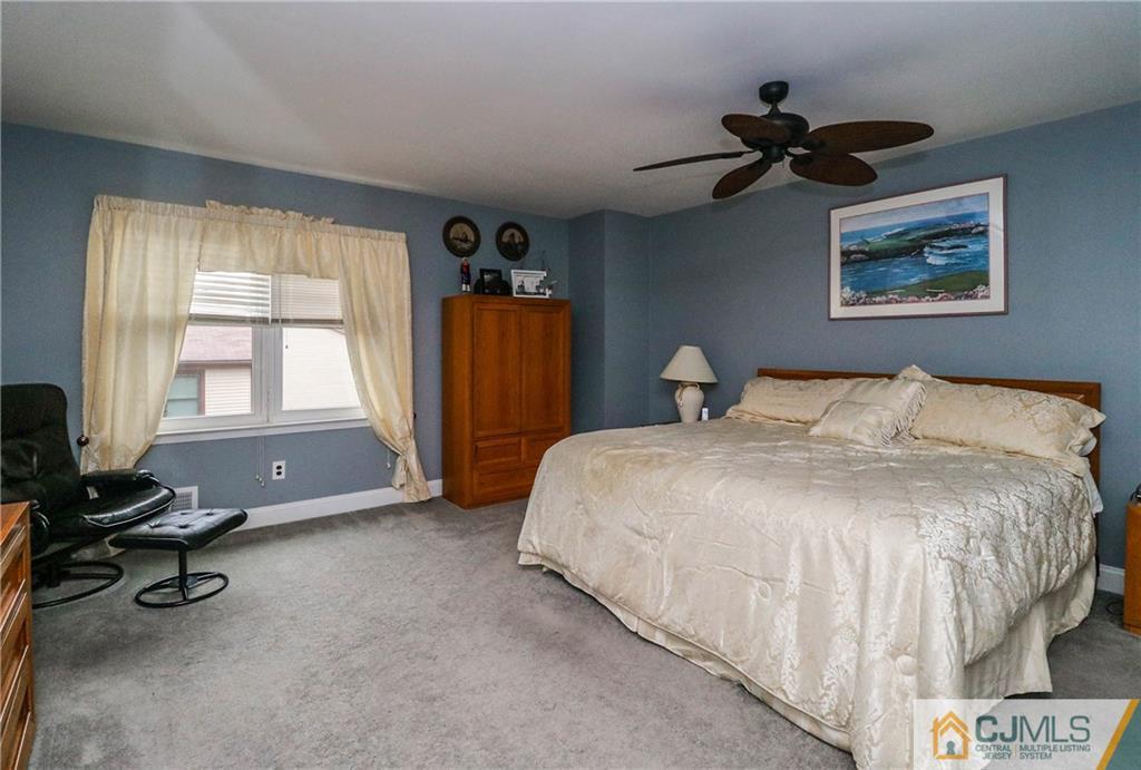 7307 Hana Road Edison, NJ 08817 - Photo 14 of 24 a bedroom with a bed dresser and a window