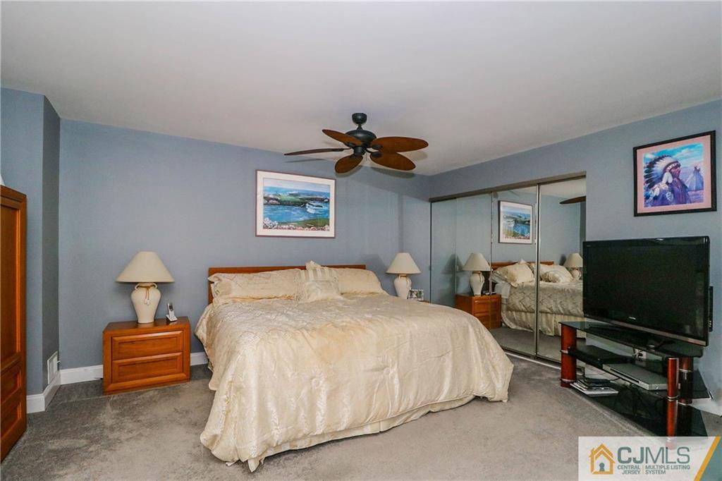 7307 Hana Road Edison, NJ 08817 - Photo 15 of 24 a bedroom with bed and a flat screen tv